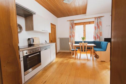a kitchen with a table and a dining room at Lesachtalerhof in Liesing