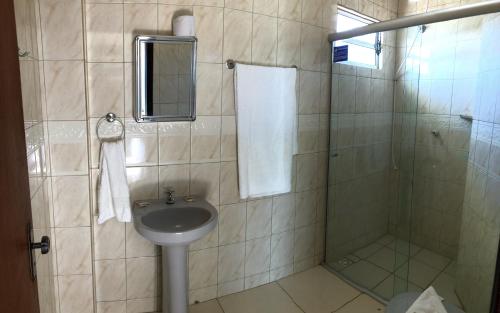 a bathroom with a sink and a shower at Hotel Pousada Mar Azul in Itapoa