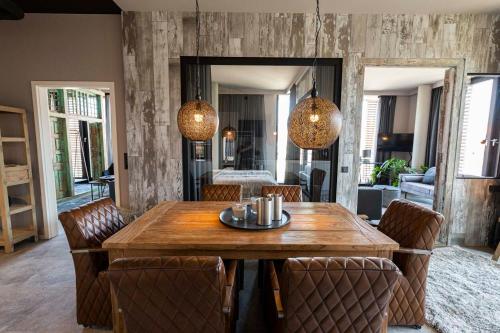 a dining room with a wooden table and chairs at Port of Travemünde, Opening 2021 in Travemünde