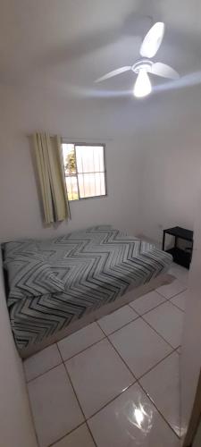 a bedroom with a bed and a ceiling fan at Ap07-A 50 Metros da Praia Flats Mobiliados para 4 pessoas in Paulista