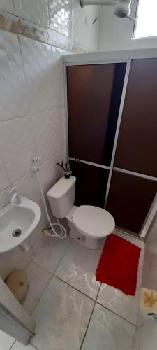 a bathroom with a toilet and a sink at Ap07-A 50 Metros da Praia Flats Completamente Mobiliados in Paulista