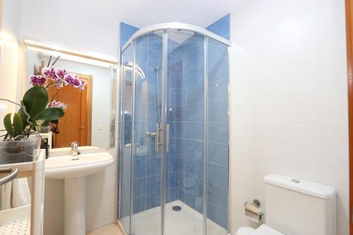 a bathroom with a shower and a toilet and a sink at El Medano - La Perla C004 in El Médano
