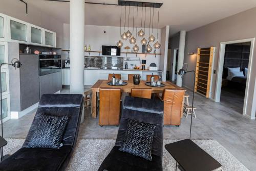 a kitchen and dining room with a table and chairs at Port of Travemünde, Opening 2021 in Travemünde