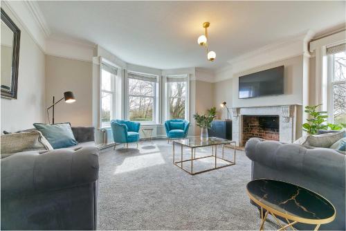 a living room with two couches and a fireplace at Host & Stay - The Old Rectory in Witton Gilbert