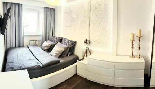 Posteľ alebo postele v izbe v ubytovaní Apartament Modrzewskiego