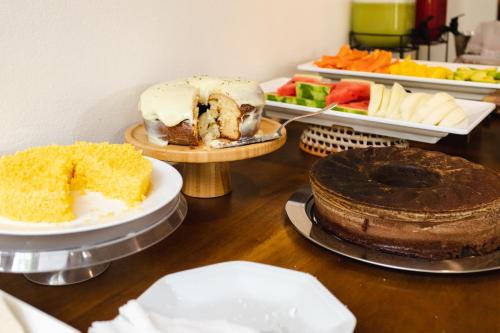 a table with different types of cakes and desserts at Jeri Pousada in Jericoacoara