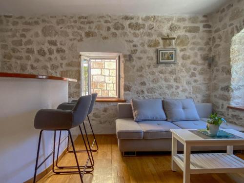 a living room with a couch and a table at City center apartment Roza in Makarska