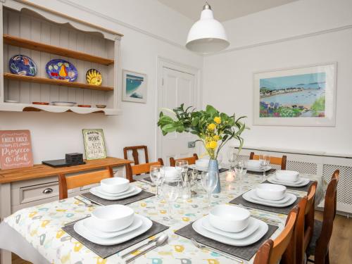 a kitchen and dining room with a table and chairs at Lluest in Beaumaris