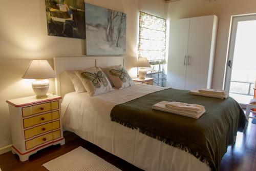 a bedroom with a bed and a night stand with a lamp at QUINTA DOS MONTEIROS - 3 Quartos com Piscina in Resende
