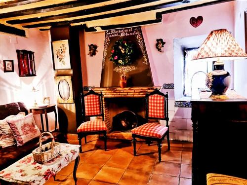 sala de estar con sofá y chimenea en La Quinta de Malu romantic hotel in Cuenca, en Valeria