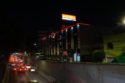 a lit up motel sign on a city street at night at Hotel Del Rey in Mexico City