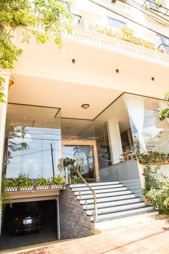 a house with a staircase in front of it at LA MIA Lakeview Hotel in Pleiku