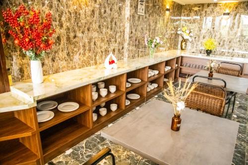 a dining room with a table and chairs at LA MIA Lakeview Hotel in Pleiku