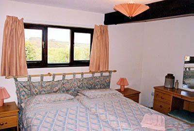 A bed or beds in a room at New Stable Cottage 