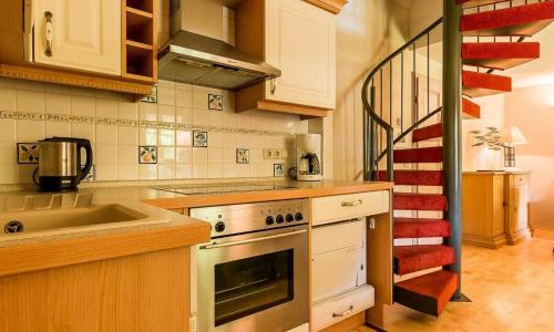 a kitchen with a sink and a stove top oven at Meermaler in Ahrenshoop