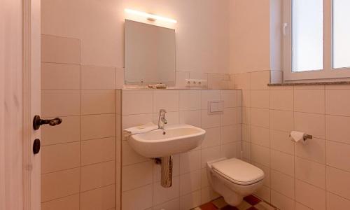 a bathroom with a sink and a toilet at Kapitänshaus - Atelier in Ahrenshoop