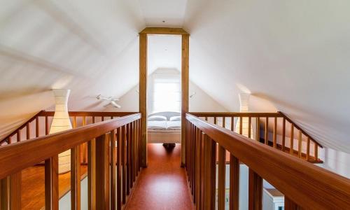 a room with a staircase with a bed in it at Alte Tischlerei 01 in Wustrow