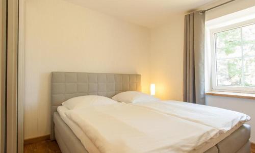 Postel nebo postele na pokoji v ubytování Haus Schilfkante - Wohnung 1