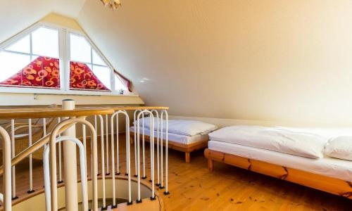 a room with two beds and a window at Madlen in Ahrenshoop