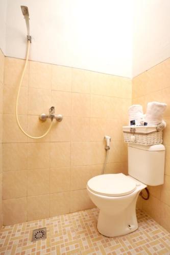 a bathroom with a toilet and a shower at DPARAGON PRINGWULUNG in Yogyakarta
