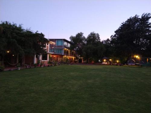 a large grass field in front of a building at Telpochcalli Hotel & Temazcal in San Juan Teotihuacán