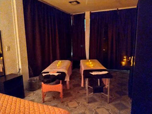a room with two tables and two chairs in it at Telpochcalli Hotel & Temazcal in San Juan Teotihuacán