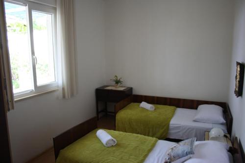 a room with two beds and a window at Apartment Nikola in Dubrovnik