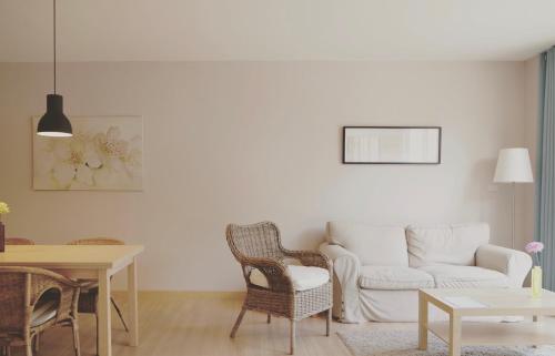 a living room with a couch and a table at Palm Crescent Hua Hin in Cha Am