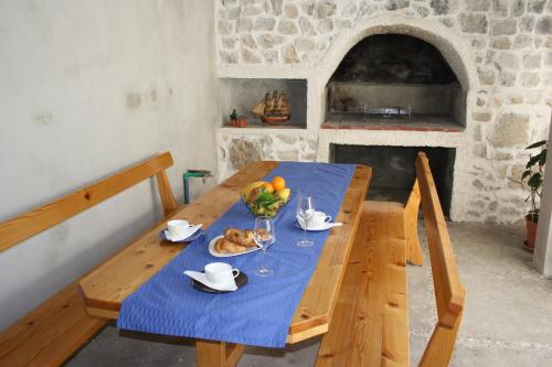 a wooden table with a bowl of fruit on it at Apartment Nikola in Dubrovnik
