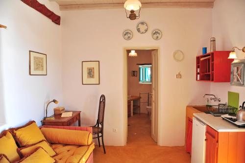 a kitchen and a living room with a couch and a table at Alonistria in Órmos Aiyialís