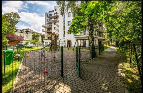 a batting cage in a park with a playground at Cicha Przystań - Apartament Wyspa Solna in Kołobrzeg