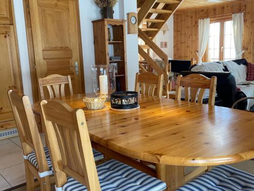 a dining room with a wooden table and chairs at Chalet Michele Alpage in Les Collons
