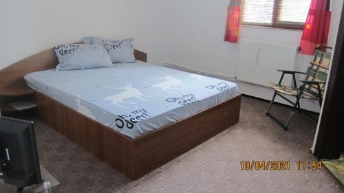 a bedroom with a bed with a picture of a man on it at Vila Thetis in Mamaia Nord