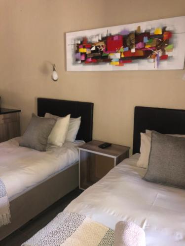 two beds sitting next to each other in a room at Jock of the Bushveld in Barberton