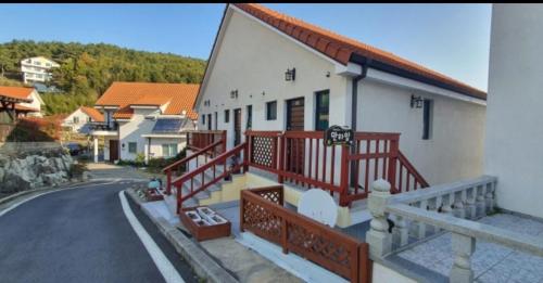 a building with red railings on the side of a street at Namhae Manheim pension in Namhae