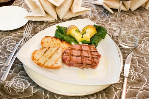 a plate of food with meat and bread on a table at Italiana Hotels Cosenza in Cosenza