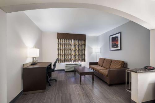 a living room with a couch and a desk at Quality Inn & Suites Huntsville Research Park Area in Huntsville
