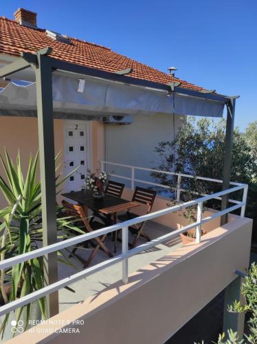 a balcony of a house with a table and chairs at Peaceful apartment with beautiful view in Hvar