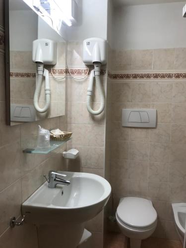 a bathroom with a sink and a toilet and a mirror at Borgo Piccolo in Cavaion Veronese