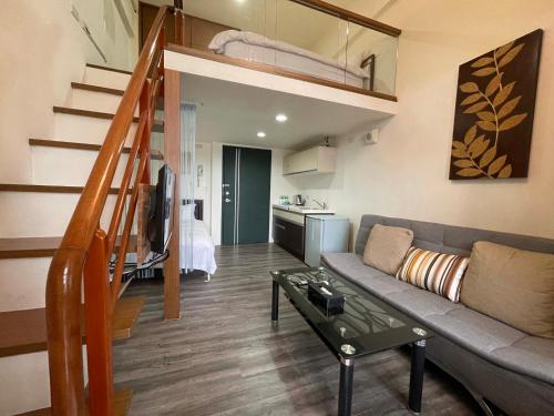 a living room with a couch and a loft at 山玥溫泉 in Jiaoxi