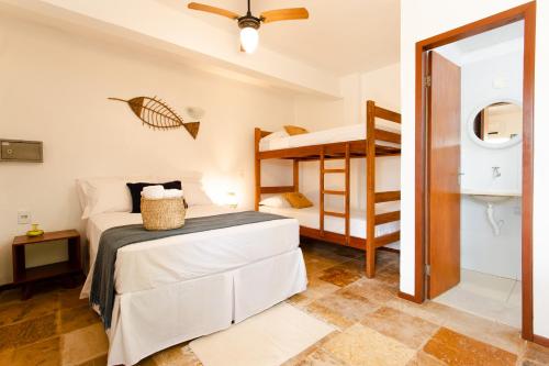 a bedroom with a bed and a bunk bed at Jeri Pousada in Jericoacoara
