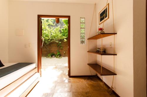 a room with a door leading to a yard at Jeri Pousada in Jericoacoara