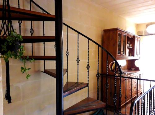a spiral staircase in a room with at Laremi Gozo B&B in Nadur