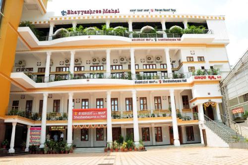 a large white building with balconies on it at Kediyoor Hotels in Udupi