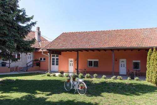 a bike parked in the yard of a house at DuMalux Garden in Subotica