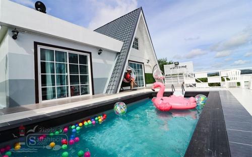 a house with a swimming pool with a pink flamingo at The I-style pool villa in Ban Tao Than