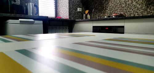 a kitchen with a counter top with colorful stripes at Nordapartament in Suceava