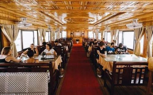 a train car filled with people sitting at tables at CatBa Sky View Hotel in Cat Ba