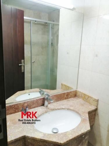 a bathroom with a sink and a shower at Studio Apartment in Dubai