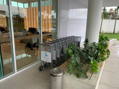 a shopping cart in front of a building with plants at SALINAS EXCLUSIVE RESORT in Salinópolis